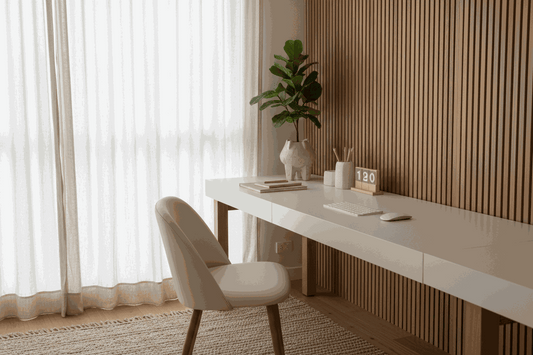 Home office desk in white with a beige upholstered chair, wooden slat panel and plant, Creating a calm workspace