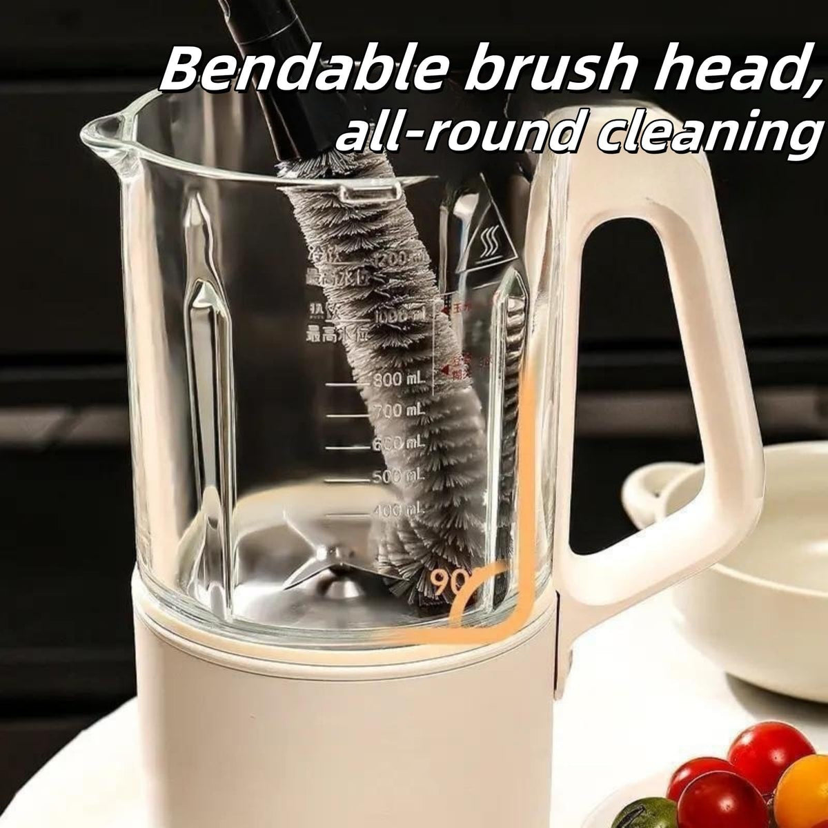2 in 1 Cleaning Brush with a dark handle and flexible gray bristles cleaning a clear blender jug