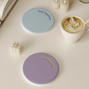 2 Pcs Blue Quick-Dry round drink coasters shown in pale blue and lavender, with smooth surfaces and printed text