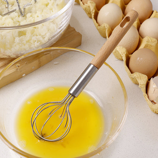 2-Piece Kitchen Tool Set with a mini stainless steel whisk and natural wood handle, shown beating egg yolk