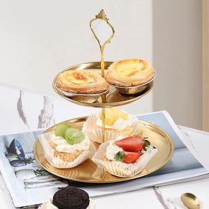 2 Tier Cupcake Stand Holder in polished gold metal with two round trays, raised rims and an ornate loop handle