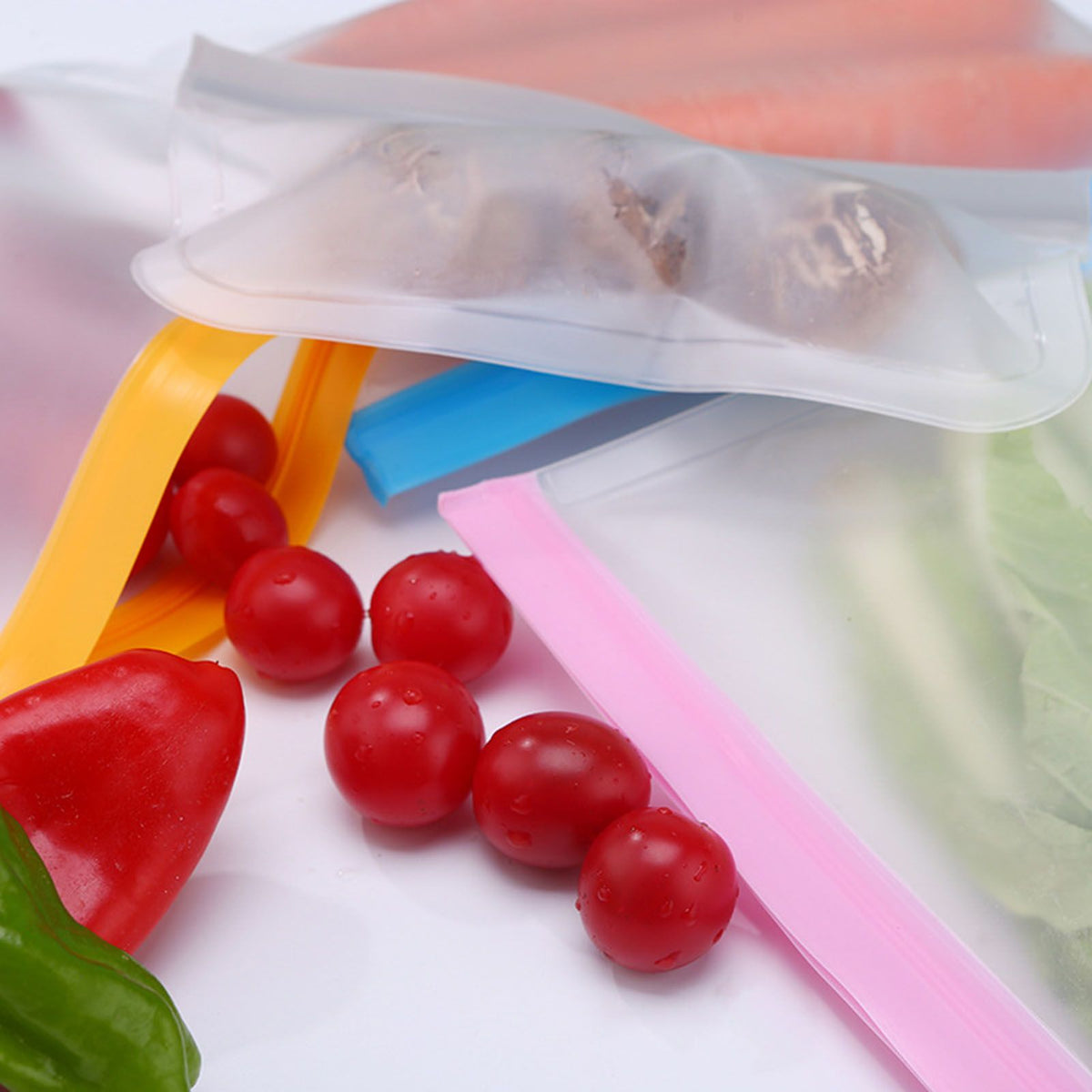 20PCS Reusable Ziplock Bags in translucent PEVA with pink, blue and yellow double-zip closures, shown with red tomatoes