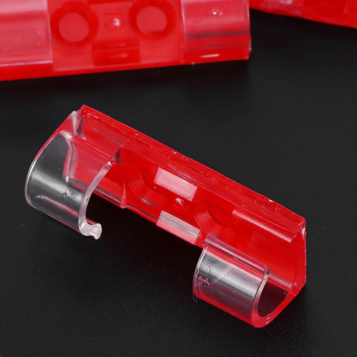 20Pcs Wire Clamp, transparent clip with a bright red plastic body and curved cable-gripping ends