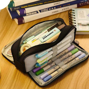 3 Compartment Pencil Case in black fabric with multiple zippered sections, elastic pen holders and colourful stationery
