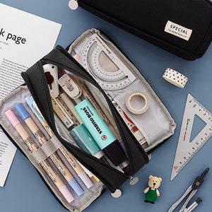 3 Compartment Pencil Case in black fabric with three zip sections, elastic pen loops and stationery neatly arranged inside