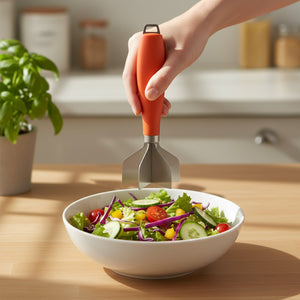 304 Stainless Steel Meat Chopper with a silver four-blade head and orange handle, held above a bowl of salad