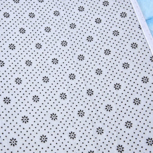 3D Pattern Doormat in white flannel with a repeating black floral and dotted pattern and a stitched edge