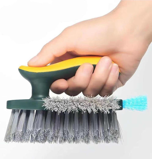 4-in-1 Grout Brush with dark green handle, yellow grip, dense gray bristles and a turquoise squeegee edge