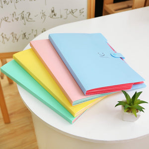 5 Pocket Expanding File Folder made of smooth plastic in pastel blue, pink, yellow and mint, with accordion edges and snap closure