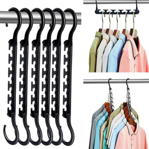 5-Tier Black Stainless Steel Pants Rack with glossy black metal rails and hooks, shown beside cascading hangers holding shirts.