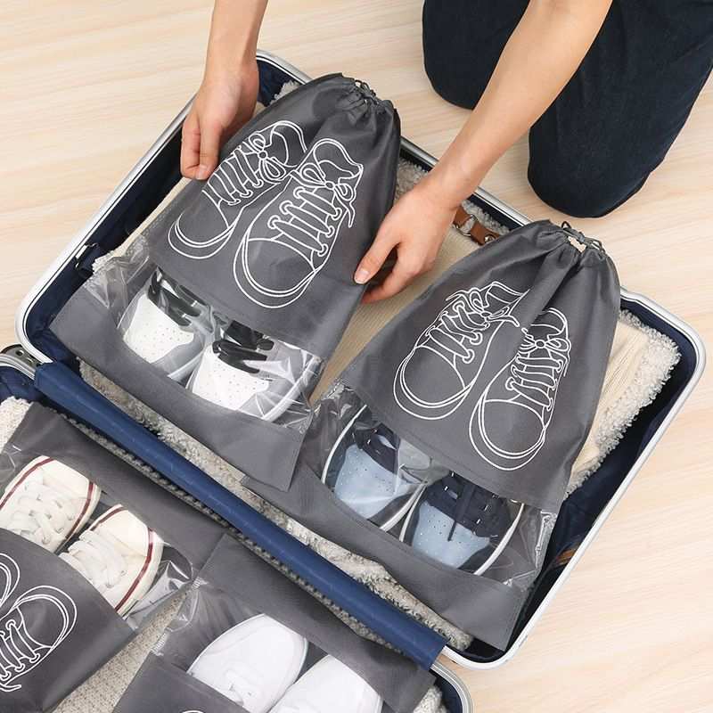 50-Pack Shoe Storage Bags, gray non-woven drawstring pouches with clear windows holding shoes for travel