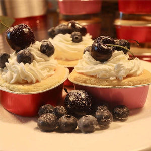 50PCS 3.5oz/100ml Mini Heart Cake Pans in red aluminum foil, filled with sponge cake and topped with whipped cream and cherries