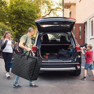 75L Large Storage Bags in black Oxford cloth with a white grid pattern, zip closure and reinforced handles, carried for moving