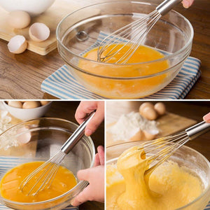 8 Inch Mini Stainless Steel balloon whisk with a polished silver handle and wire loops, mixing eggs in a glass bowl