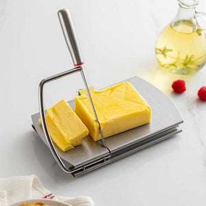 Stainless steel cheese slicer with a silver gridded board, wire cutter and grey handle, slicing yellow cheese