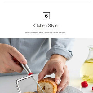 Stainless steel cheese slicer with a gridded cutting board, wire frame, red accents and anti-slip feet slicing bread