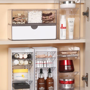 Low Profile Clear Storage Box in transparent plastic with multiple drawers, compartments and skincare products neatly arranged