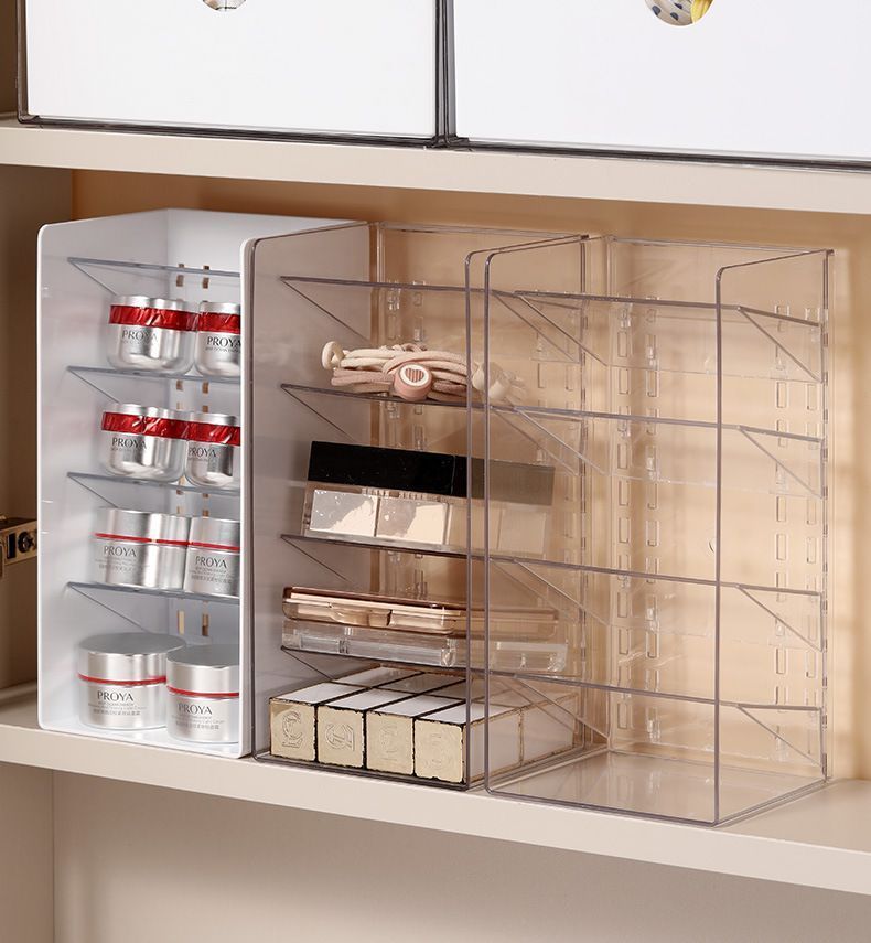 Low Profile Clear Storage Box in transparent plastic, with a tall divided grid organiser holding cosmetics and skincare jars