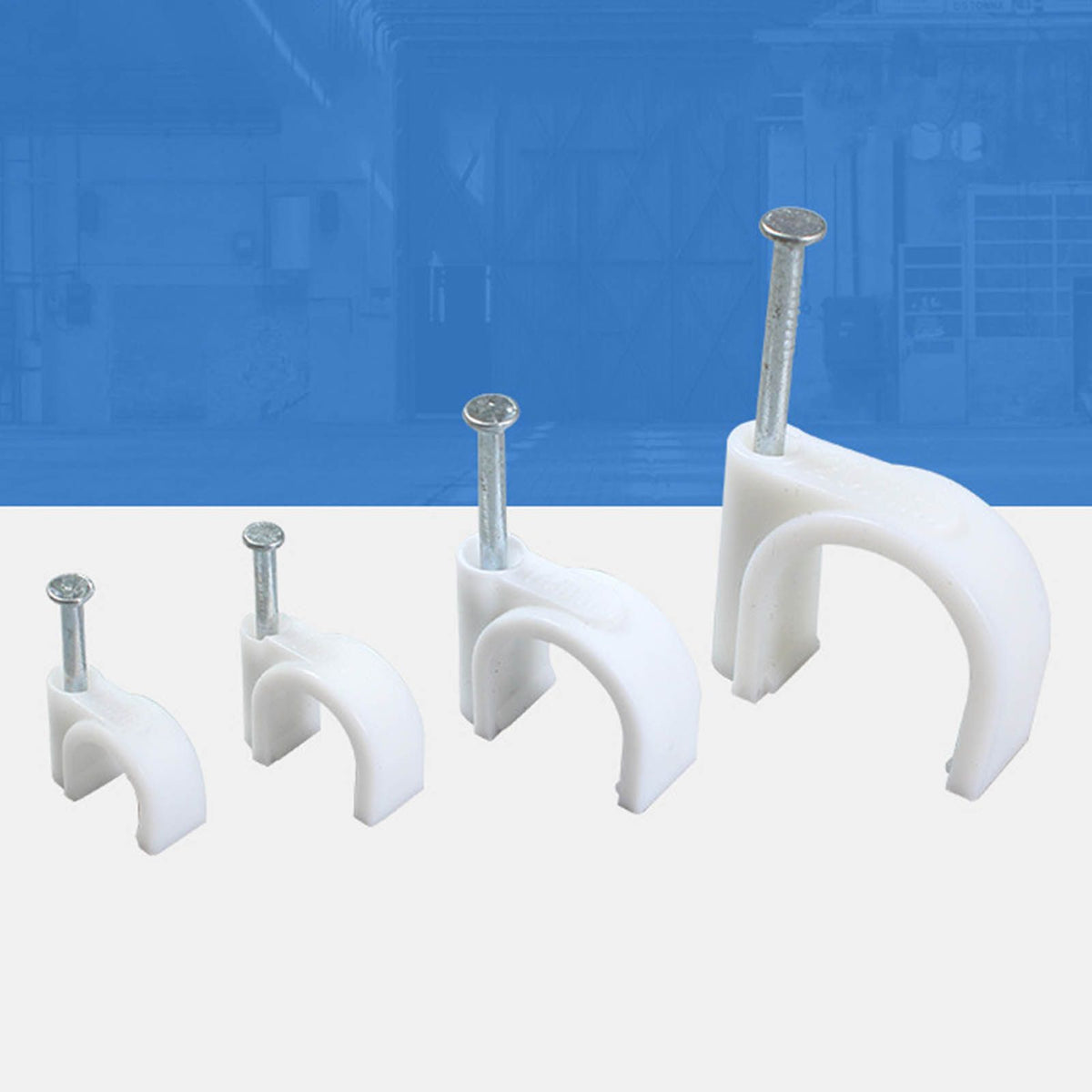 Steel Nail Cable Fixing Clips in white plastic with silver steel nails, shown in four sizes with curved snap-fit arches