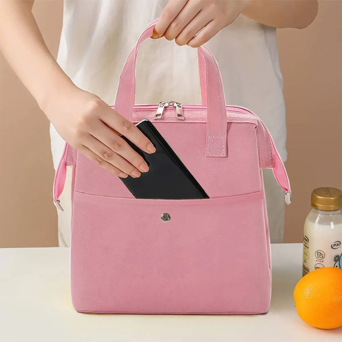 Insulated Lunch Bag in pink Oxford cloth with dual handles, a front pocket, metal zipper and side pockets