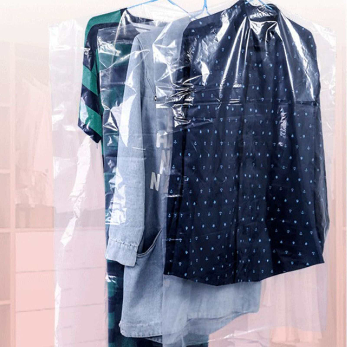 Hanging Garment Bag in clear semi-transparent plastic, covering several shirts including a navy patterned shirt