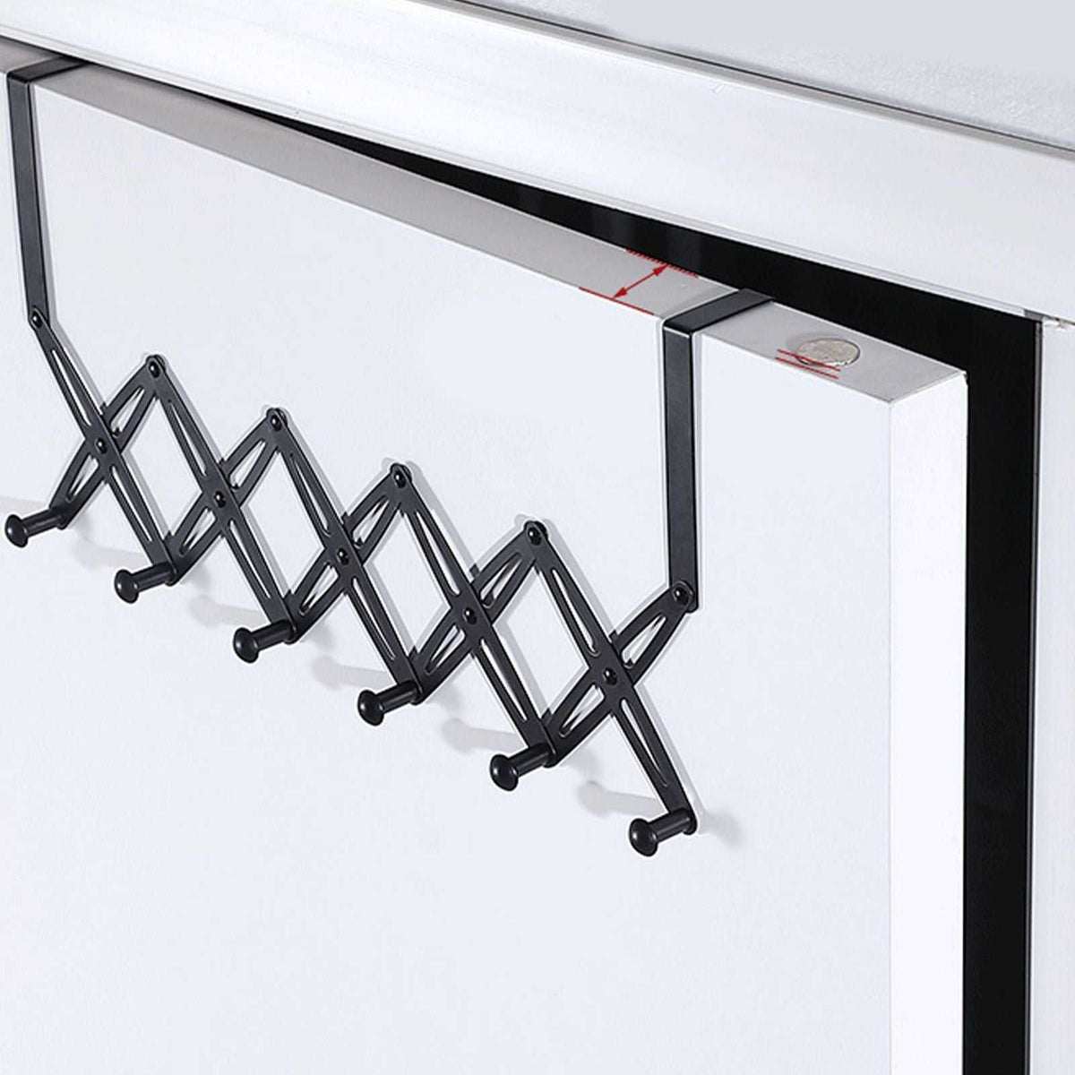 Over Door Hooks in black metal with an expandable criss-cross frame and six rounded hanging pegs.