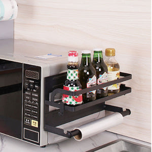 Refrigerator Magnetic Storage Shelf in black metal, featuring two raised rails and a lower paper towel holder, with bottles stored on top