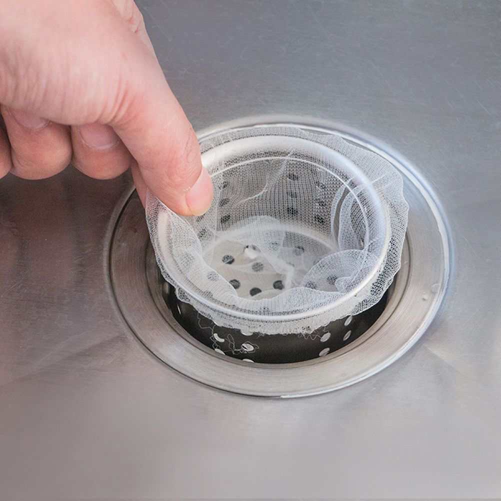200 Pcs Sink Strainer Bag in fine white polyester mesh, stretched over a metal drain strainer with an elastic rim