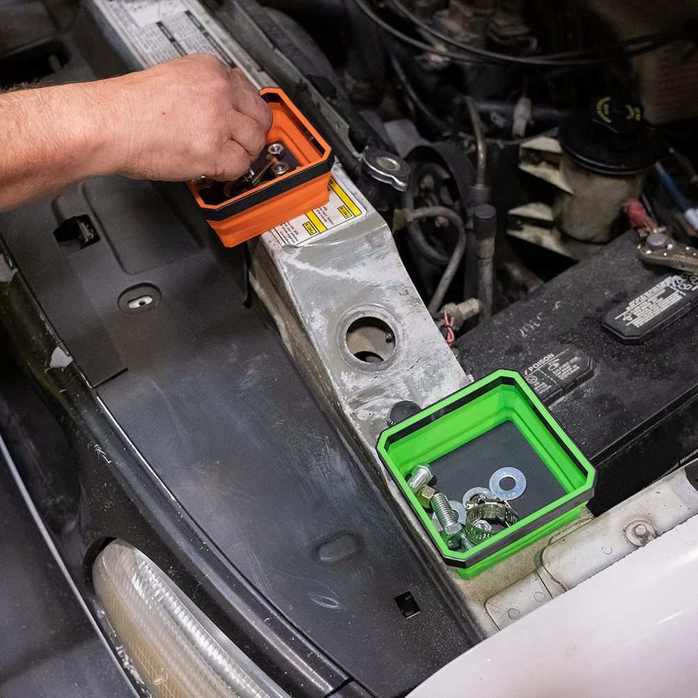 Magnetic Parts Tray set with bright orange and green collapsible silicone trays holding metal screws and washers