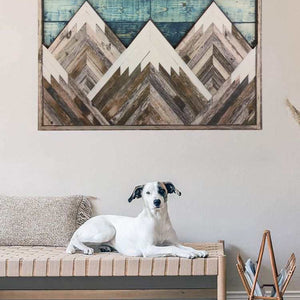 Mountain Wood Wall Art featuring layered geometric peaks in weathered brown and white wood, with a blue plank accent