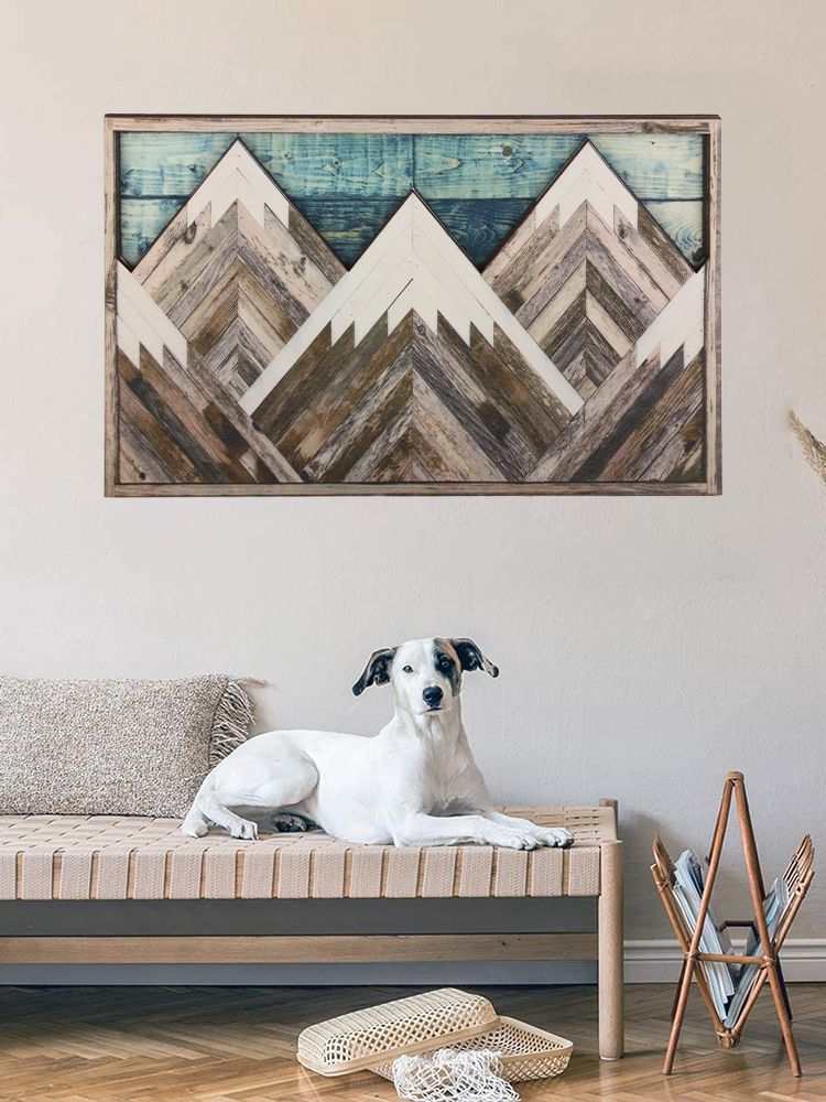 Mountain Wood Wall Art featuring layered geometric peaks in weathered brown and white wood, with a blue plank accent