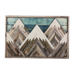 Mountain Wood Wall Art with layered geometric peaks in weathered brown and white wood, framed over teal plank detail