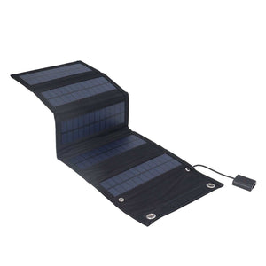 9W Solar Panel foldable charger with dark fabric backing, blue-black solar cells, metal eyelets and USB cable