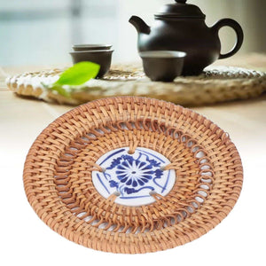 Blue and White Porcelain Coaster with a natural tan woven rattan rim and a blue floral porcelain center