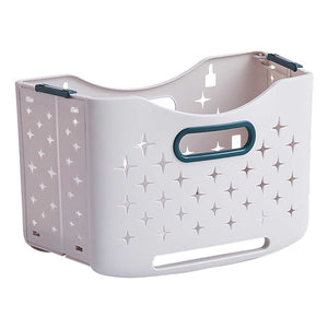 Collapsible Laundry Basket in pale lavender plastic with star-shaped ventilation cutouts and teal-edged handles