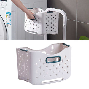 Collapsible Laundry Basket in pale lavender plastic with dark teal handles, perforated star patterns and a fold-flat design