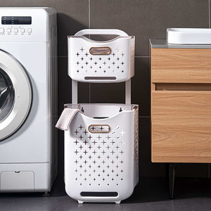 Collapsible Laundry Basket in white plastic with star-shaped ventilation holes, integrated handles and a stacked design