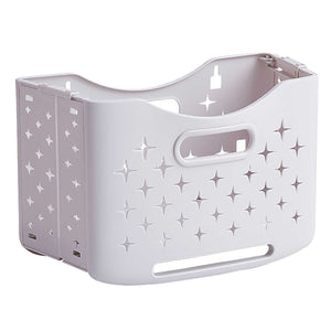 Collapsible Laundry Basket in pale ivory plastic with star-shaped ventilation cutouts and integrated carry handles