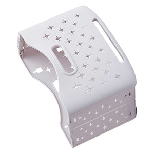 Collapsible Laundry Basket in pale ivory plastic, folded flat with star-shaped ventilation cutouts and elongated carry handles