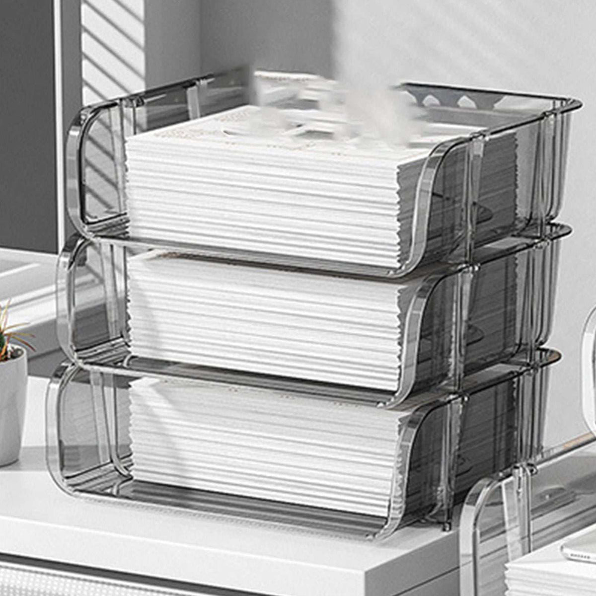 Transparent Desktop Stationery Organizer in clear plastic, stacked in three tiers with wavy sides and white papers