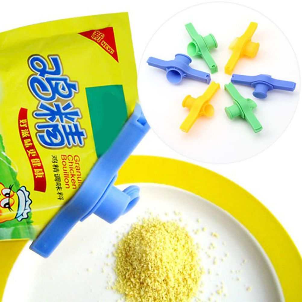 Random Food Bag sealing clip in blue, green and yellow plastic, with an integrated pouring nozzle shown attached to seasoning packaging
