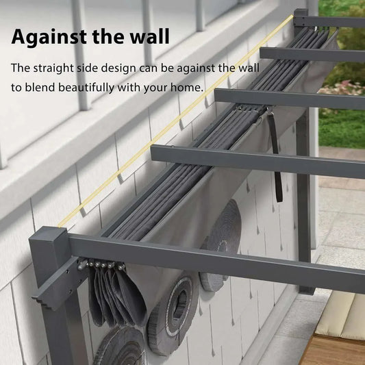 Outdoor pergola with a dark grey aluminium frame and folded retractable canopy, designed for mounting against a wall