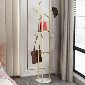 Marble & Metal Coat Rack with a slender gold metal tree frame, round white base, branching hooks and shelf, holding a hat and bag