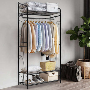 Extra Large Iron Clothes Rack in black metal with three mesh shelves, curved side details, a hanging rod and clothes.