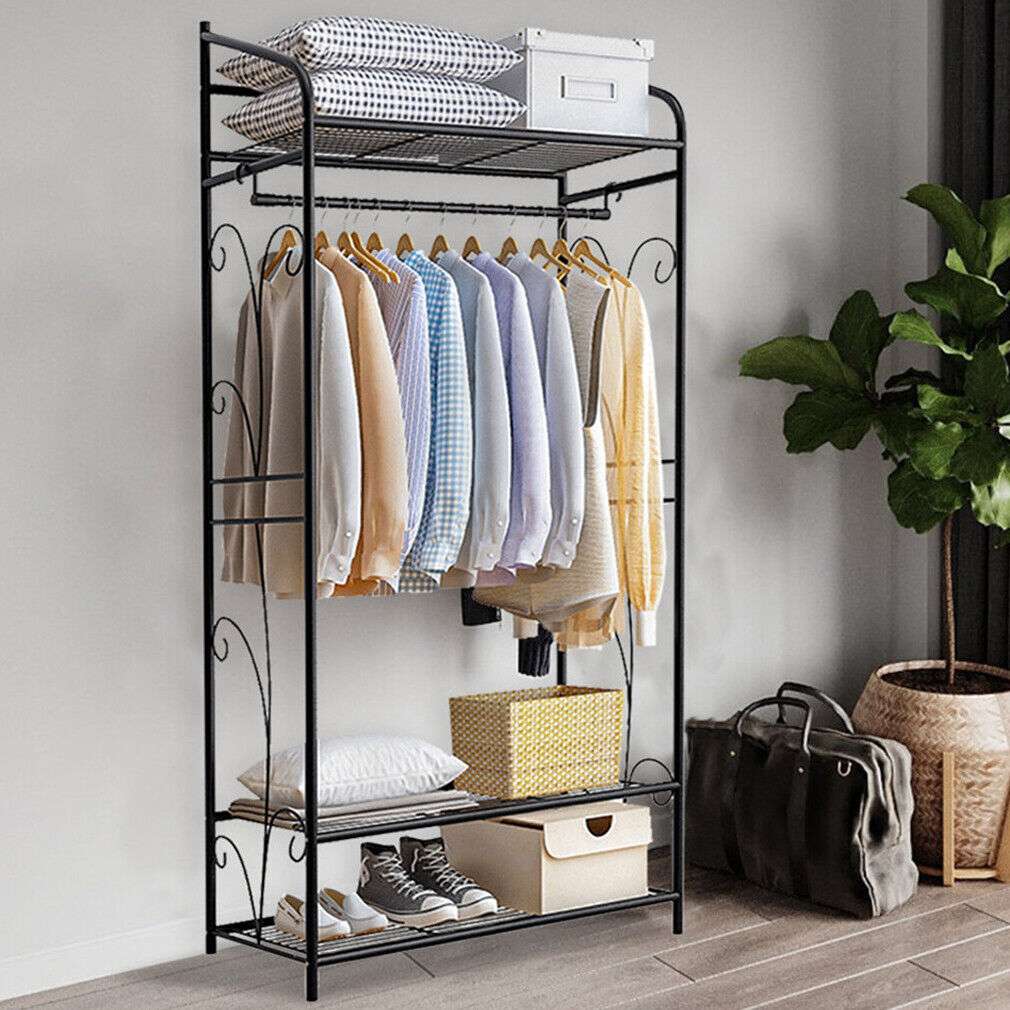 Extra Large Iron Clothes Rack in black metal with three mesh shelves, curved side details, a hanging rod and clothes.