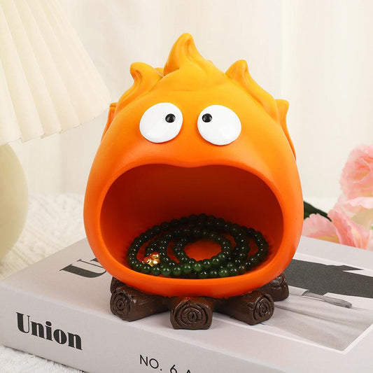Creative Cartoon Flame Key Holder Tray in bright orange resin, with wide open mouth, googly eyes and brown stump-like feet