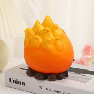 Creative Cartoon Flame Key Holder Tray in bright orange resin, shaped as a smiling flame above a dark brown base.