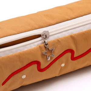 Coffee Vibrant Color Block pencil case in tan fabric with red embroidered wavy trim, white zipper and star-shaped pull
