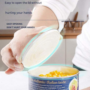 2pc Multifunctional Safe-Cut Can Opener shown lifting a can lid with a smooth edge, revealing yellow corn inside