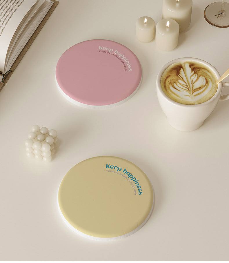 2 Pcs Blue Quick-Dry diatom mud coasters shown as smooth round pastel pink and pale yellow cup mats.
